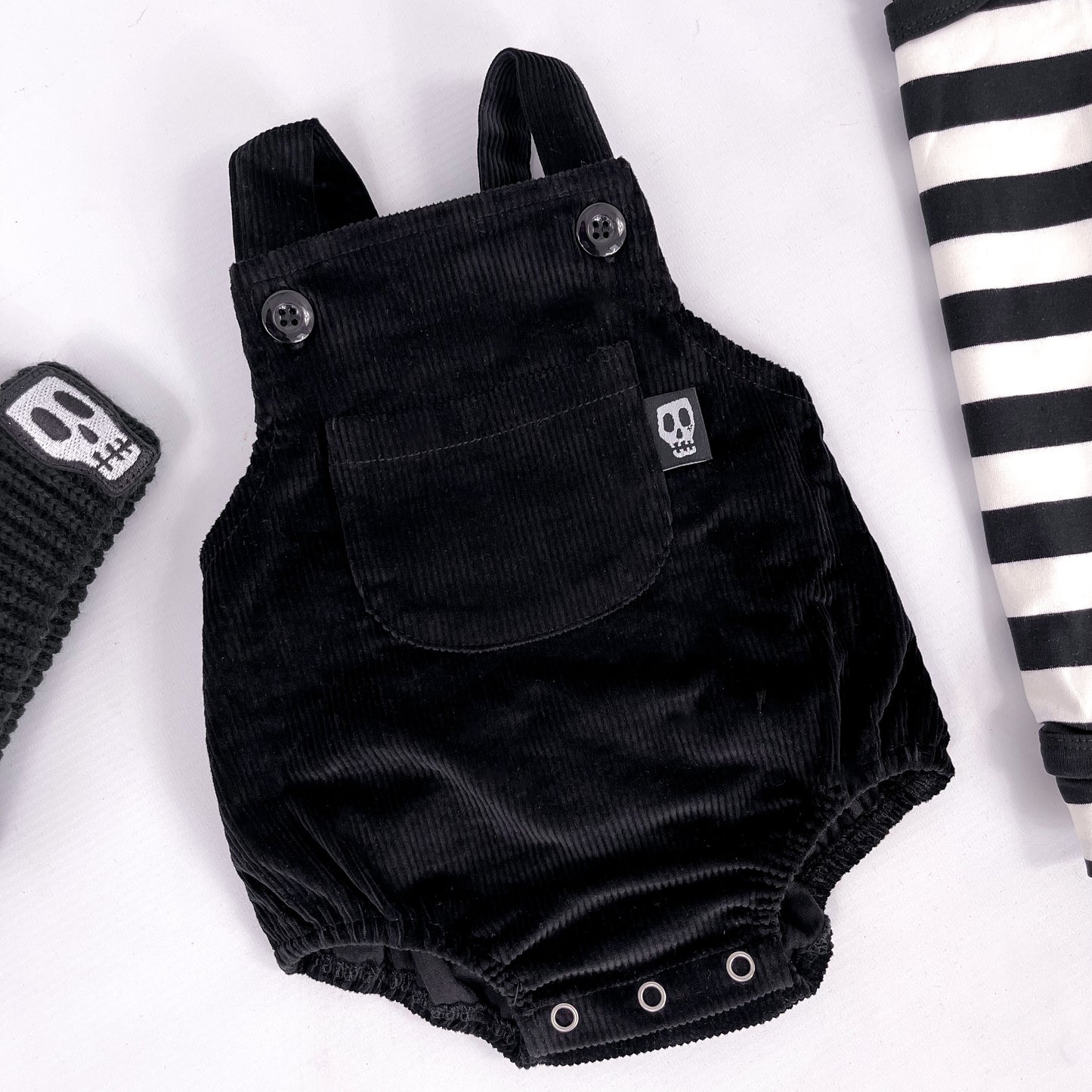 Black cord baby romper with front bib pocket