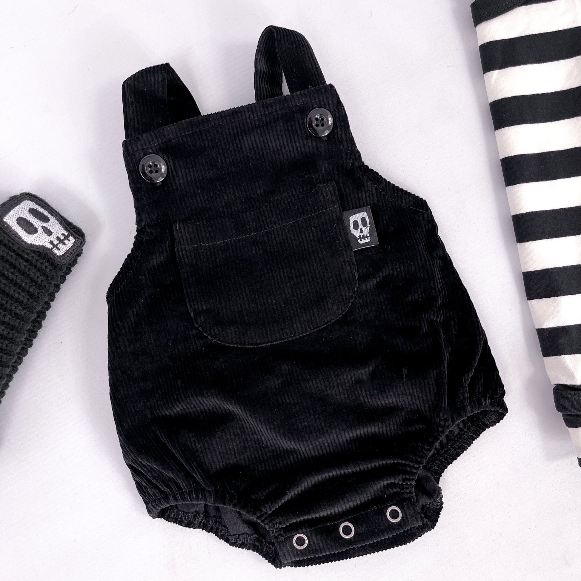 Black cord baby romper with front bib pocket