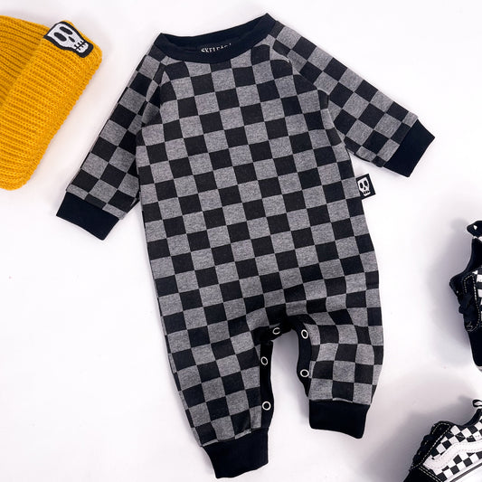 Footless baby romper in checkerboard grey and black