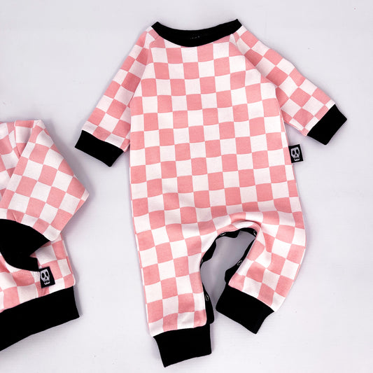 Footless baby romper with pink and white checkerboard design