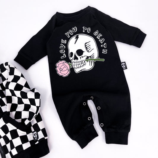 Black baby romper with "love you to death" printed on and a design of a skull holding a rose in its teeth
