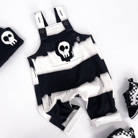 Kids black and white striped dungarees with skull patch and dripping paint design