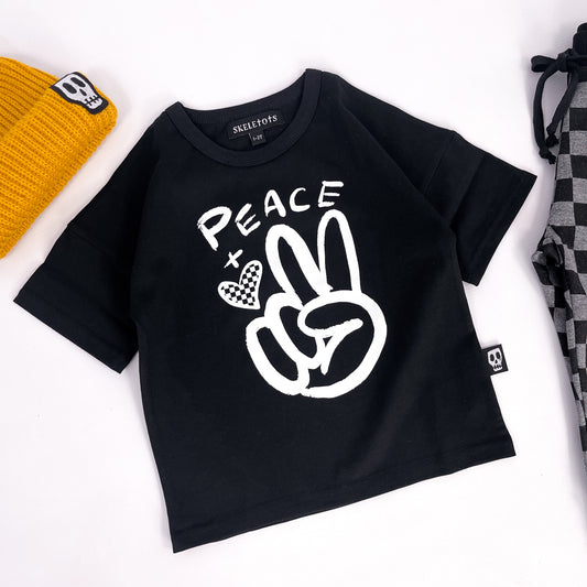 Kids black t shirt with design of a hand giving the peace sign and the word "peace"