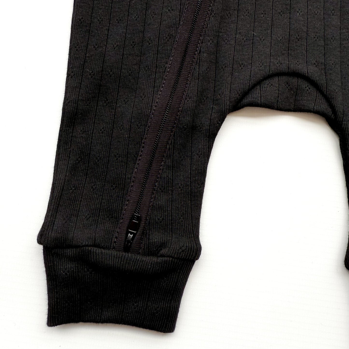 BABY POINTELLE BLACK ZIP UP FOOTLESS ROMPER