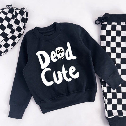 Kids sweatshirt with "Dead Cute" printed on with a skull in place of the "A"