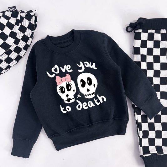 Kids sweatshirt with "Love you to death" printed on and 2 skulls, one with a pink ribbon