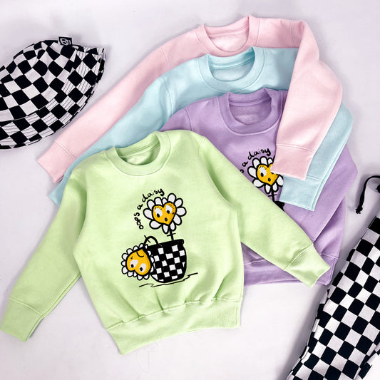 Kids pastel pink sweatshirt with wilting flower and "oops a daisy" printed on