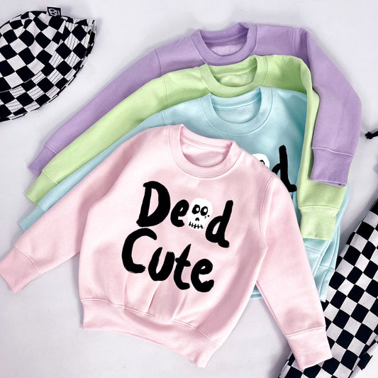 Kids pastel pink sweatshirt with "Dead Cute" printed on 