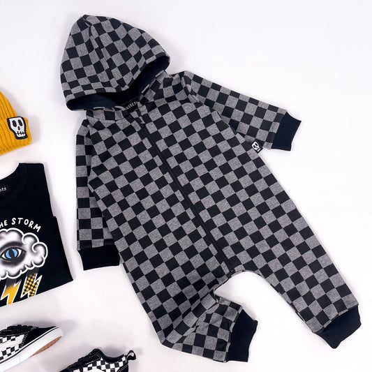Kids zip up all in one body suit in checkerboard grey and black