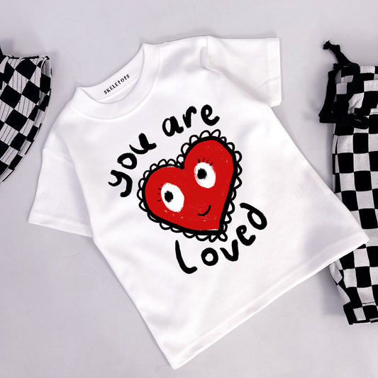 Kids white tee shirt with heart and "you are loved" printed on