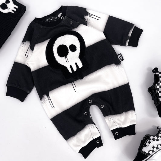 Black and white striped footless baby romper with skull patch and dripping paint design