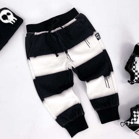 Kids black and white striped joggers with dripping paint design
