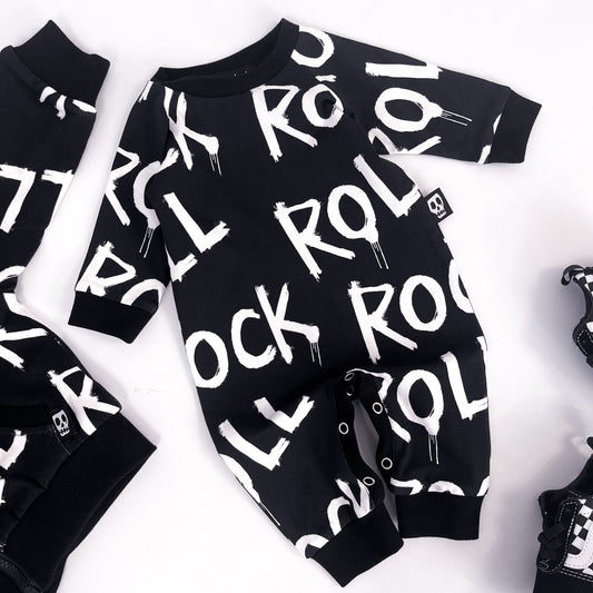 Footless baby romper with words "rock" and "roll" printed on it repeatedly