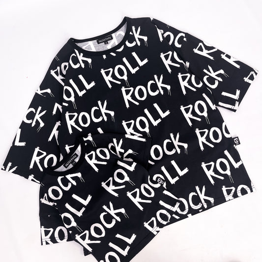 Black tee shirt with words "rock" and "roll" printed on it repeatedly
