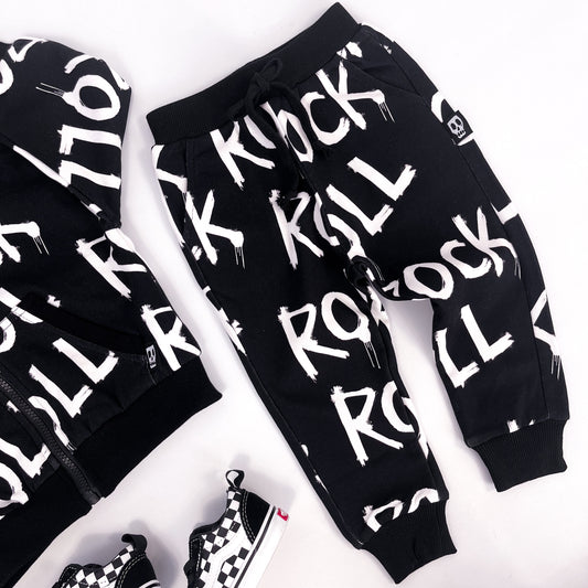 Kids black joggers with words "rock" and "roll" printed on it repeatedly