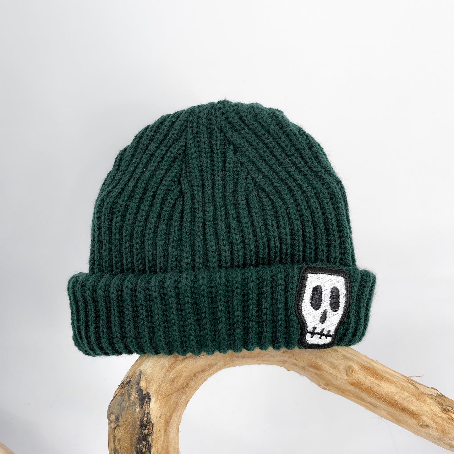 Kids trawler beanie, green with embroidered Skelly Skull logo 